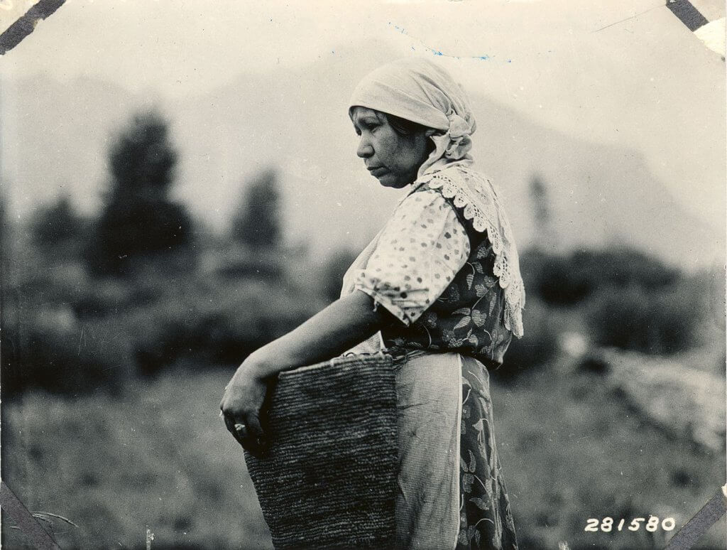 Native American women with basket of huckleberries
